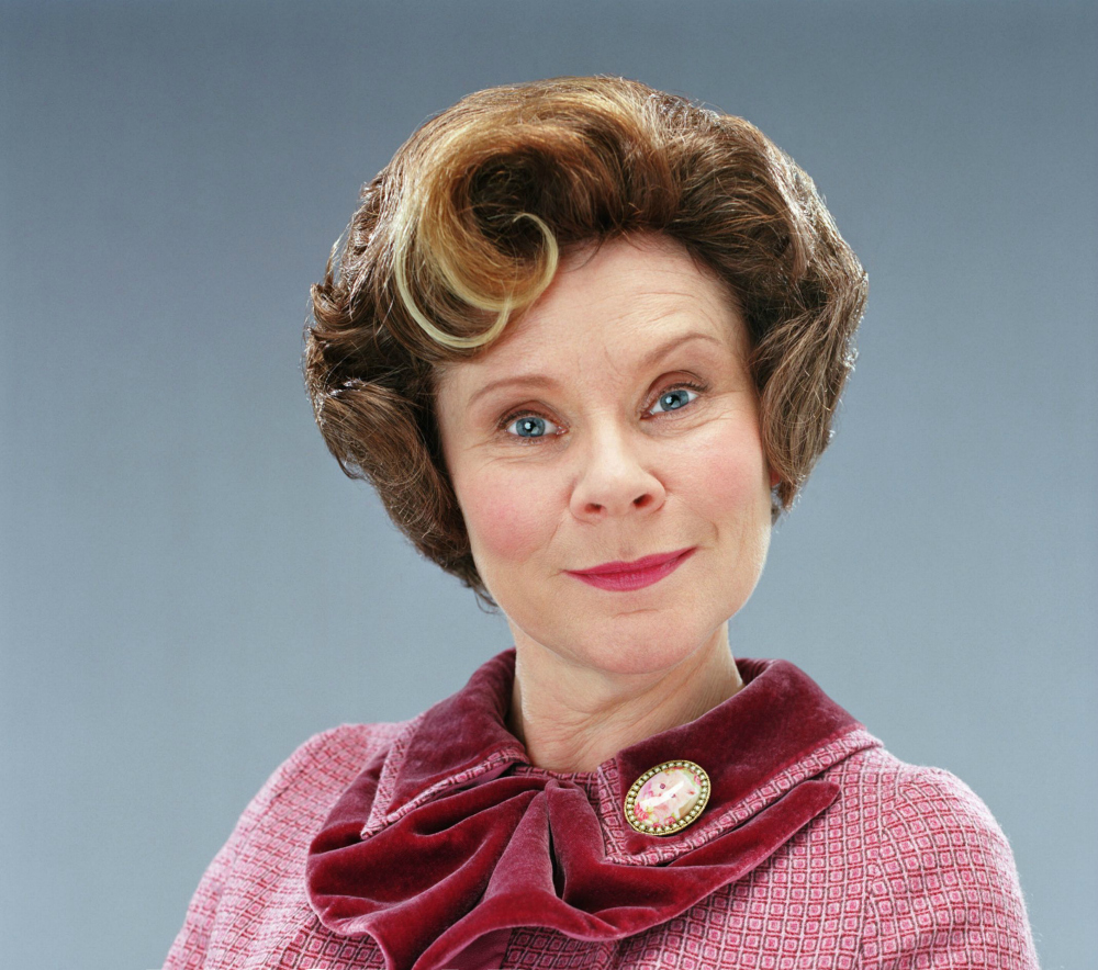 Undersecretary Umbridge wearing a pink suit and smiling